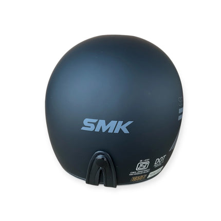 Rear view of matte black SMK motorcycle helmet with safety certification labels